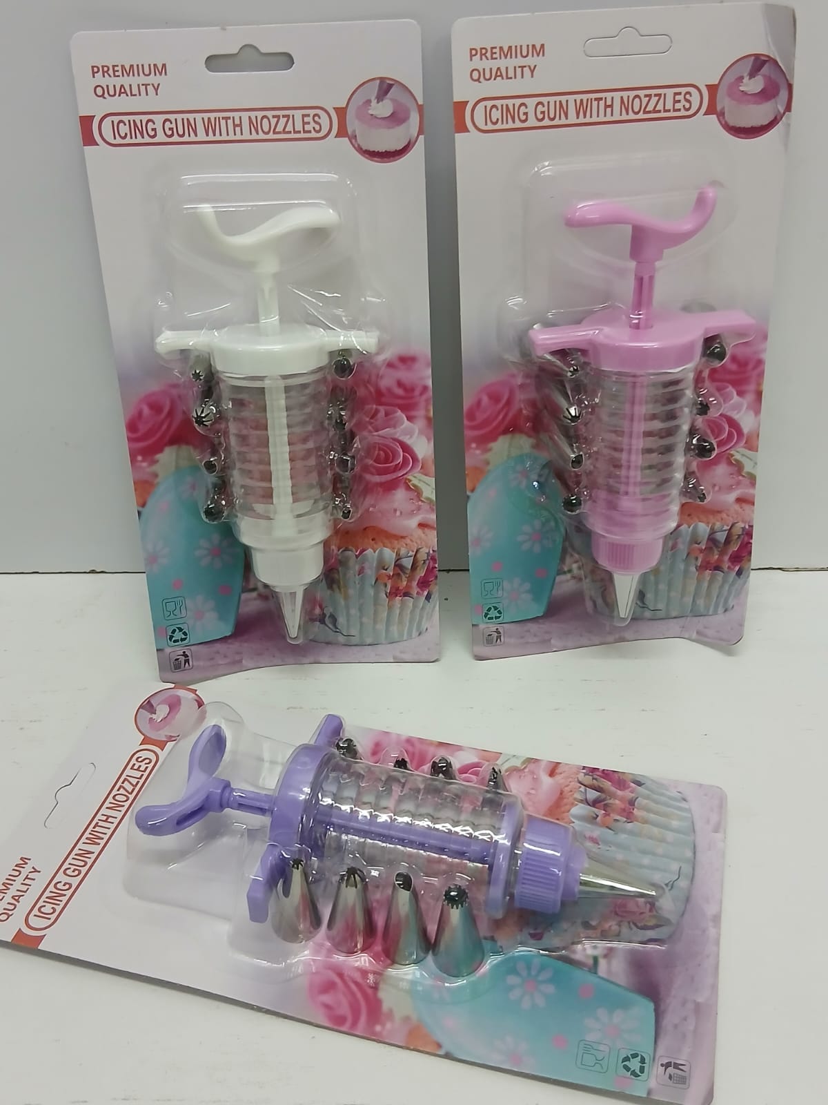 Cake icing noozles plus gun,Material: Stainless steel noozles with plastic gun, Colours: White, Pink and Purple