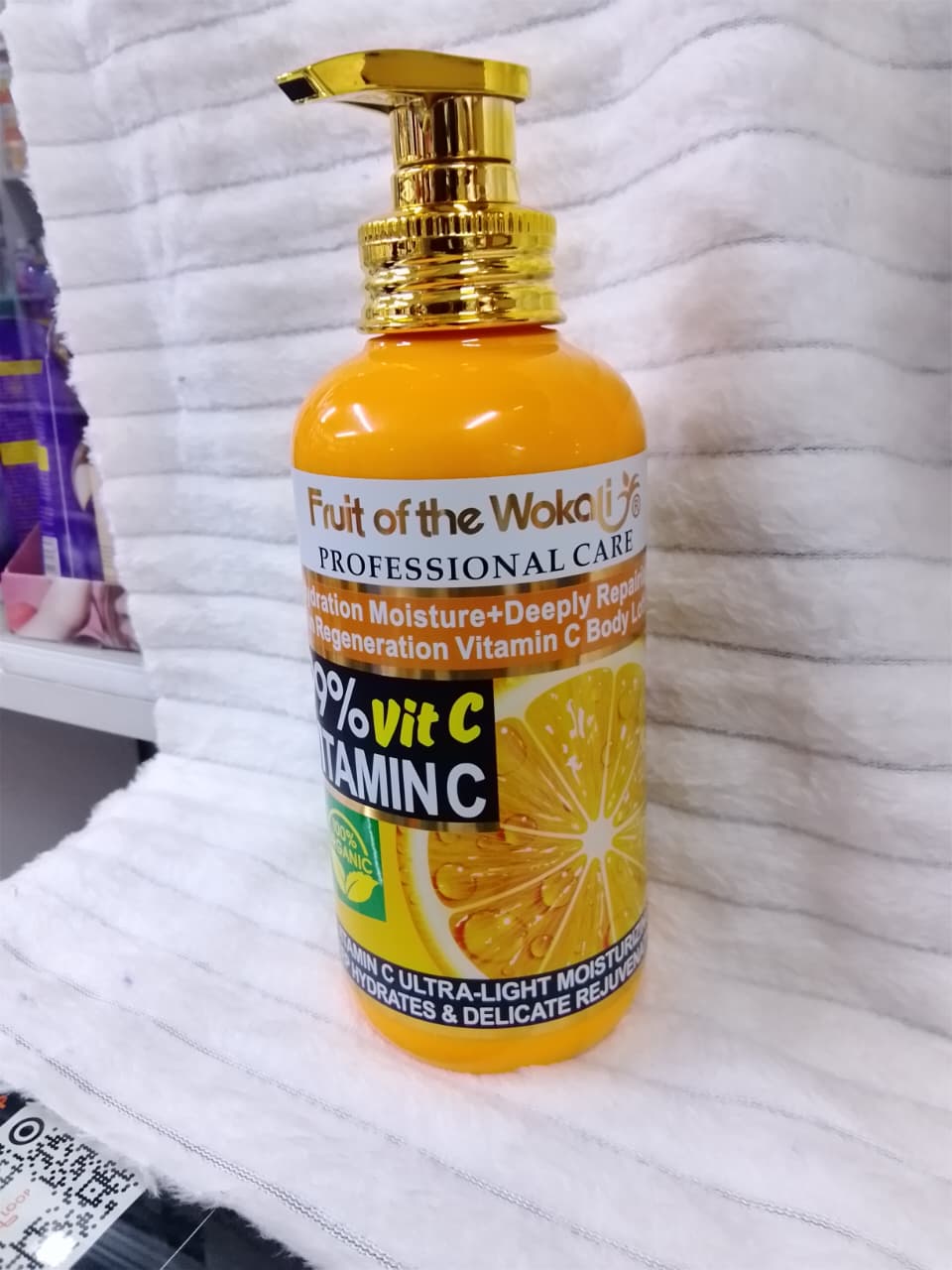 500ml bottle of Fruit of the Wokali Professional Care 99% Vitamin C Body Lotion with a gold-colored pump dispenser.