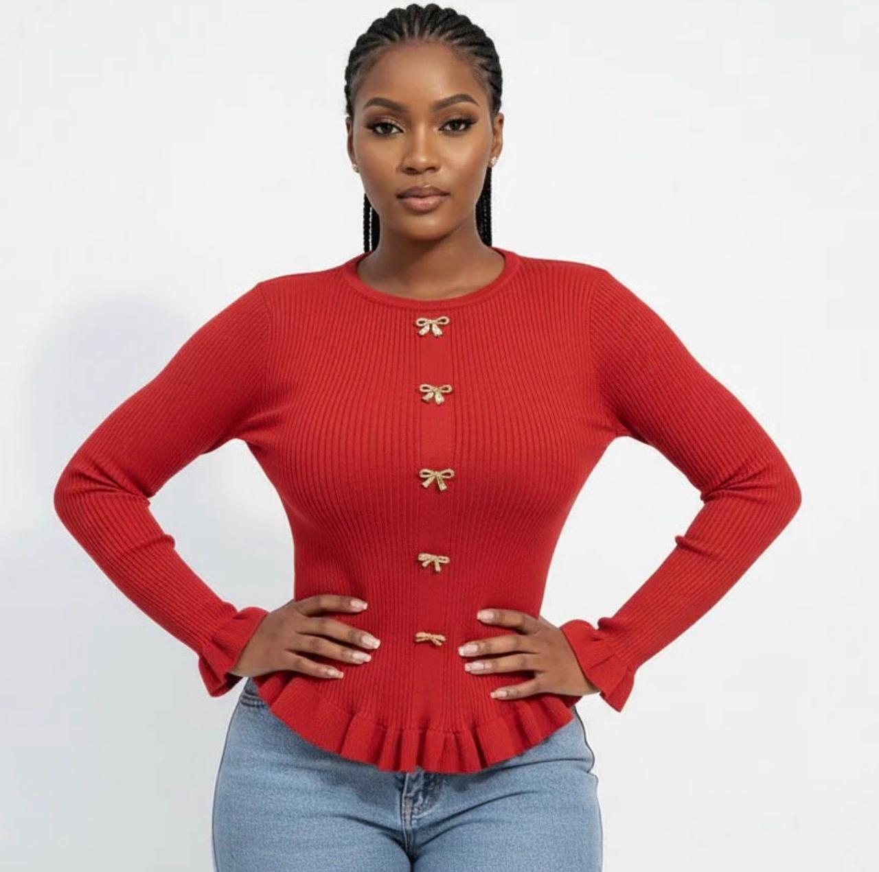 A knitted cardigan or sweater top characterized by its prominent silver/gold-tone heart-shaped buttons and has a slightly cropped length with long, voluminous balloon sleeves that end in ribbed cuffs.