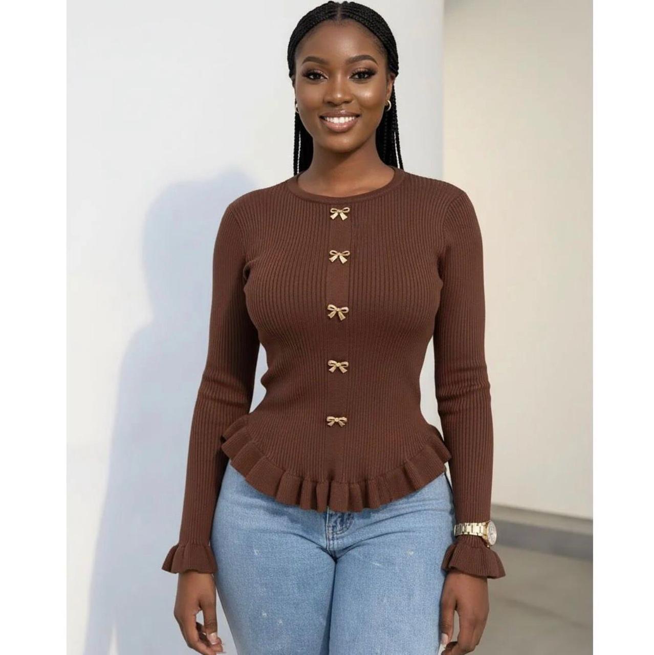 A knitted cardigan or sweater top characterized by its prominent silver/gold-tone heart-shaped buttons and has a slightly cropped length with long, voluminous balloon sleeves that end in ribbed cuffs.