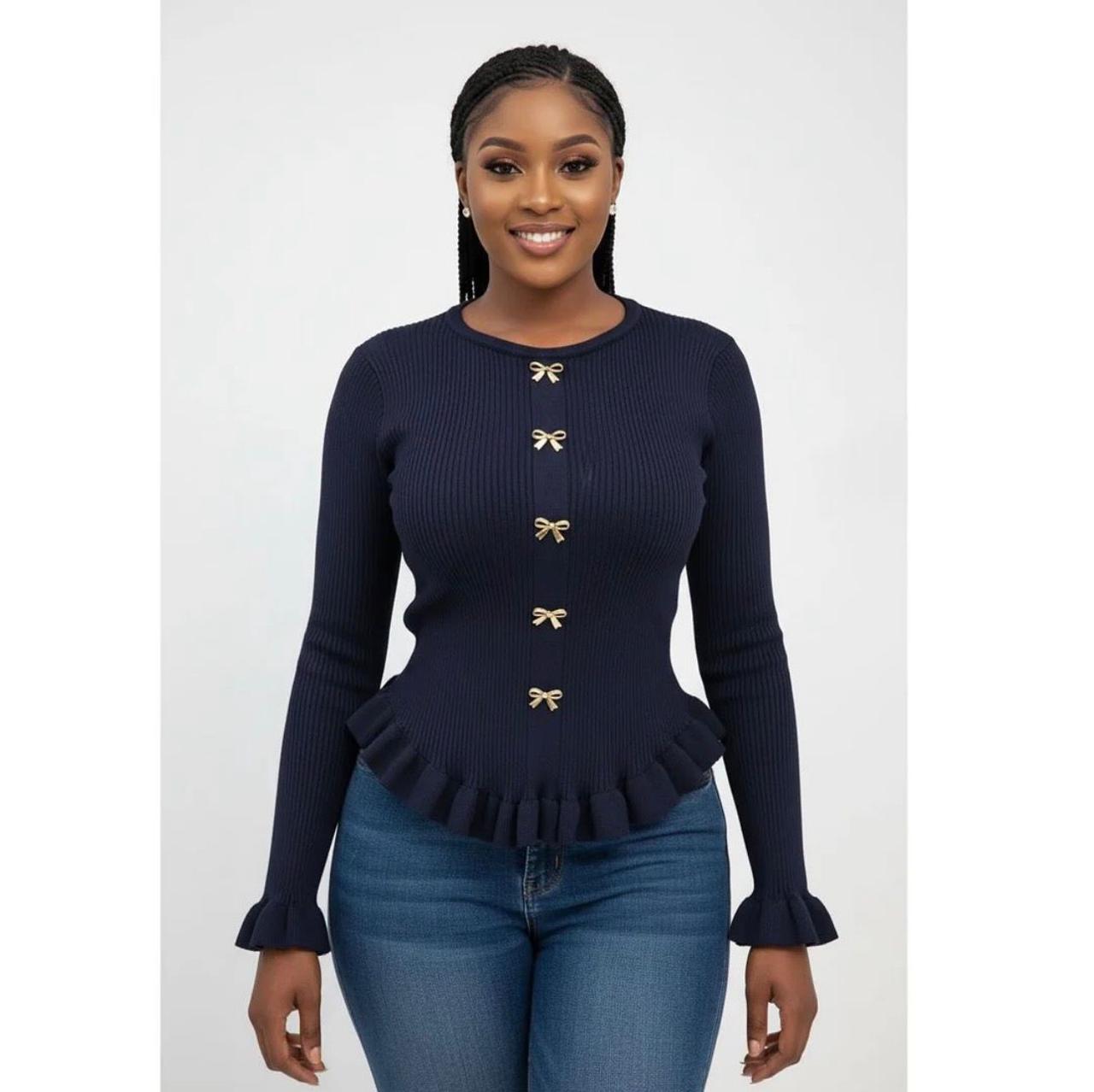 A knitted cardigan or sweater top characterized by its prominent silver/gold-tone heart-shaped buttons and has a slightly cropped length with long, voluminous balloon sleeves that end in ribbed cuffs.