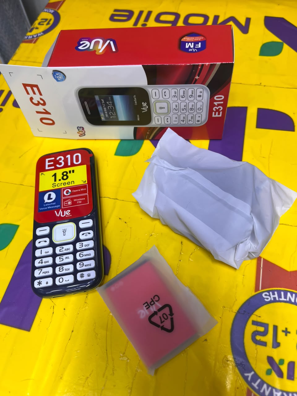 VUE E310 IS AN AFFORDABLE DUAL-SIM FEATURE PHONE FEATURING A 1.77-INCH SCREEN, A WIRELESS FM RADIO, AND A BUILT-IN TORCH LIGHT (OFTEN STYLED LOCALLY AS A "MULIKA MWIZI" OR "KABAMBE" PHONE