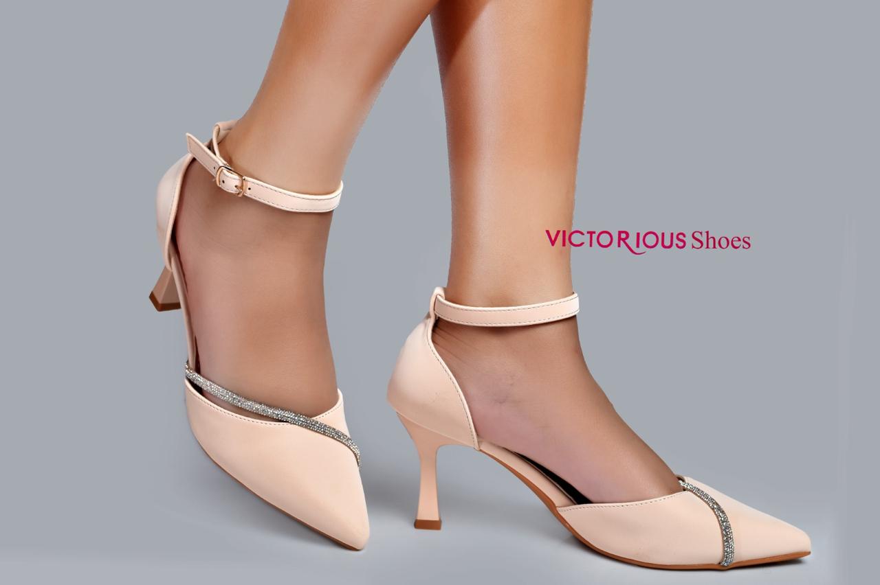 Elegant black pointed-toe kitten heels by Victorious Shoes. They feature a chic ankle strap with a delicate buckle, a subtle cut out, and a stunning curved rhinestone accent across the toe.