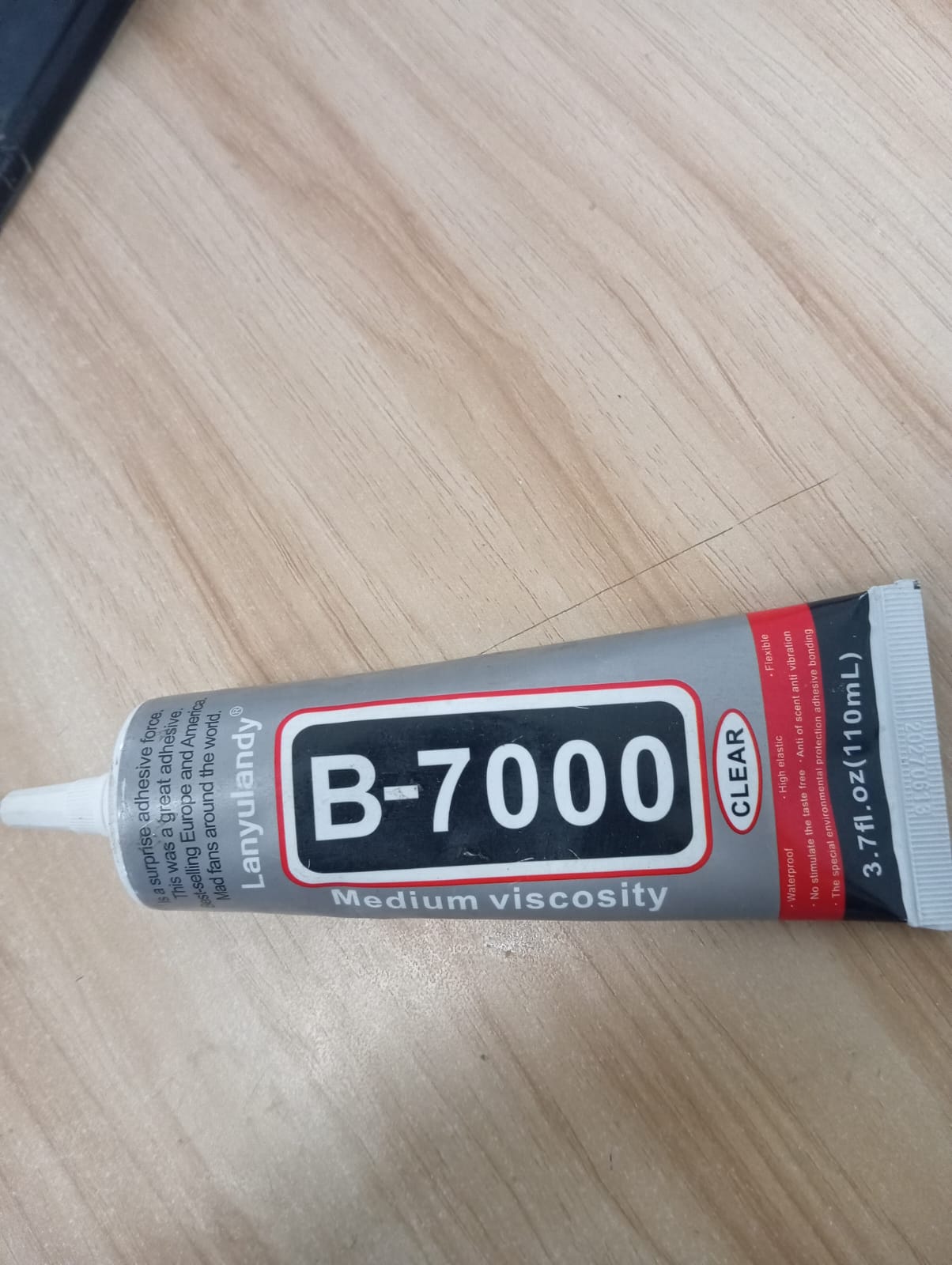 B-7000 medium viscosity clear multi-purpose adhesive tube (110ml / 3.7 fl. oz), commonly used for crafts, jewelry, and phone screen repairs.