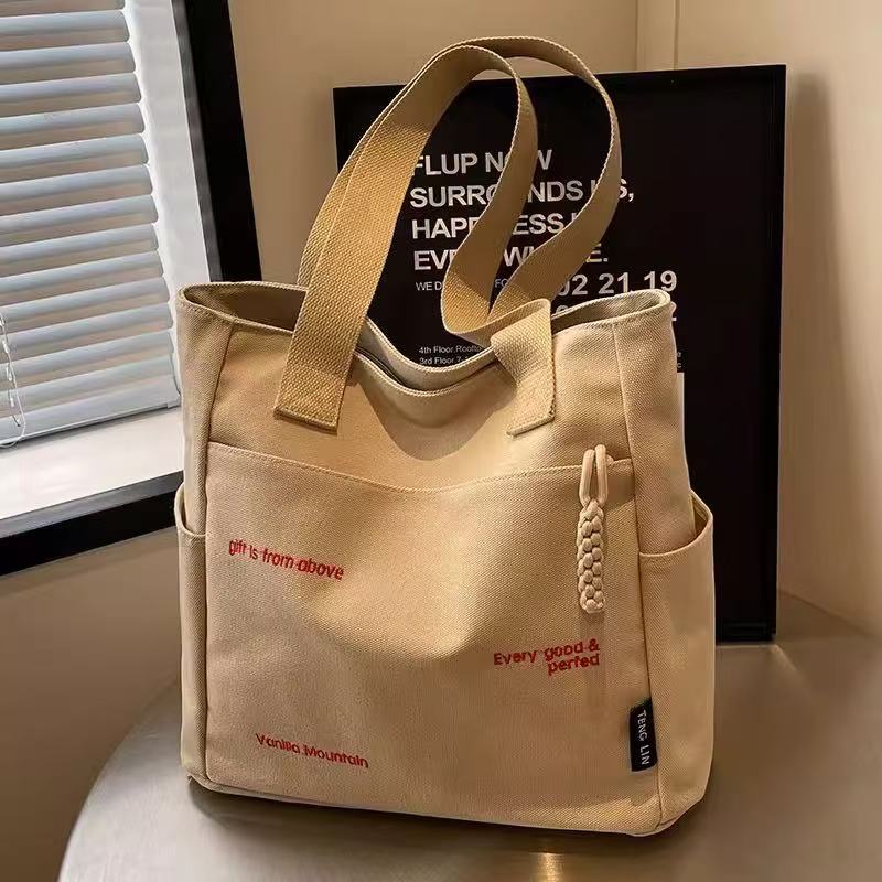 Canvas bag women's men's new trendy embroidery letter handbag student large capacity single shoulder tote bag office commuter crossbody bag