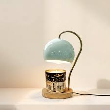 Nordic-style electric candle warmer lamp features a green hemispherical shade and a natural wood base