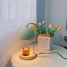 Nordic-style electric candle warmer lamp features a green hemispherical shade and a natural wood base