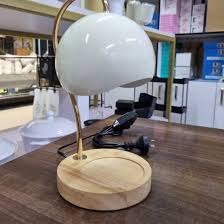 Nordic-style electric candle warmer lamp features a green hemispherical shade and a natural wood base