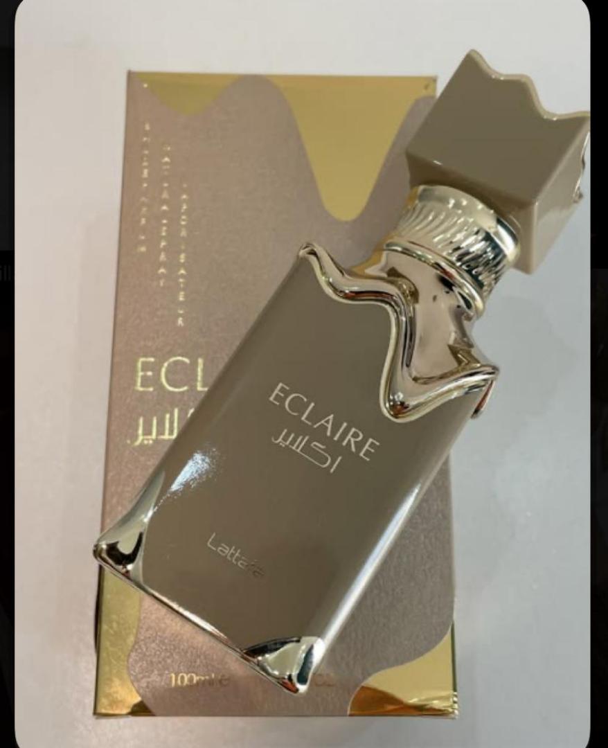 Lattafa Eclaire is a 100ml gourmand Eau de Parfum with a sweet, dessert-like profile. Notes of caramel, vanilla, and sugar create a warm, indulgent scent reminiscent of pastry. The bottle and box fe