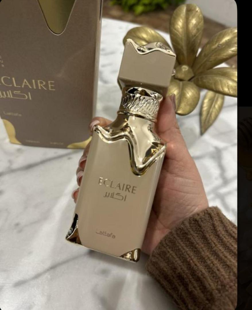 Lattafa Eclaire is a 100ml gourmand Eau de Parfum with a sweet, dessert-like profile. Notes of caramel, vanilla, and sugar create a warm, indulgent scent reminiscent of pastry. The bottle and box fe