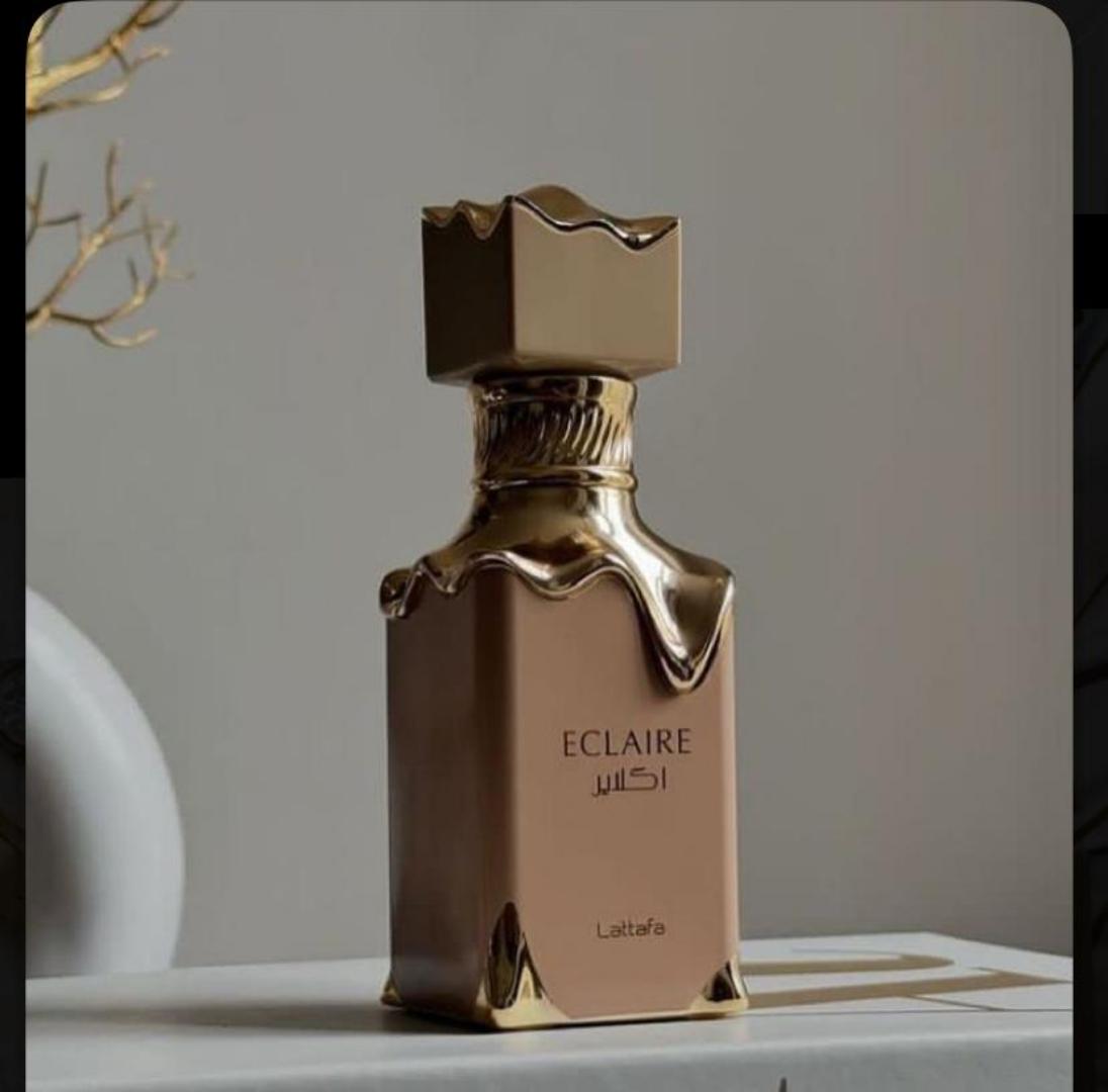 Lattafa Eclaire is a 100ml gourmand Eau de Parfum with a sweet, dessert-like profile. Notes of caramel, vanilla, and sugar create a warm, indulgent scent reminiscent of pastry. The bottle and box fe