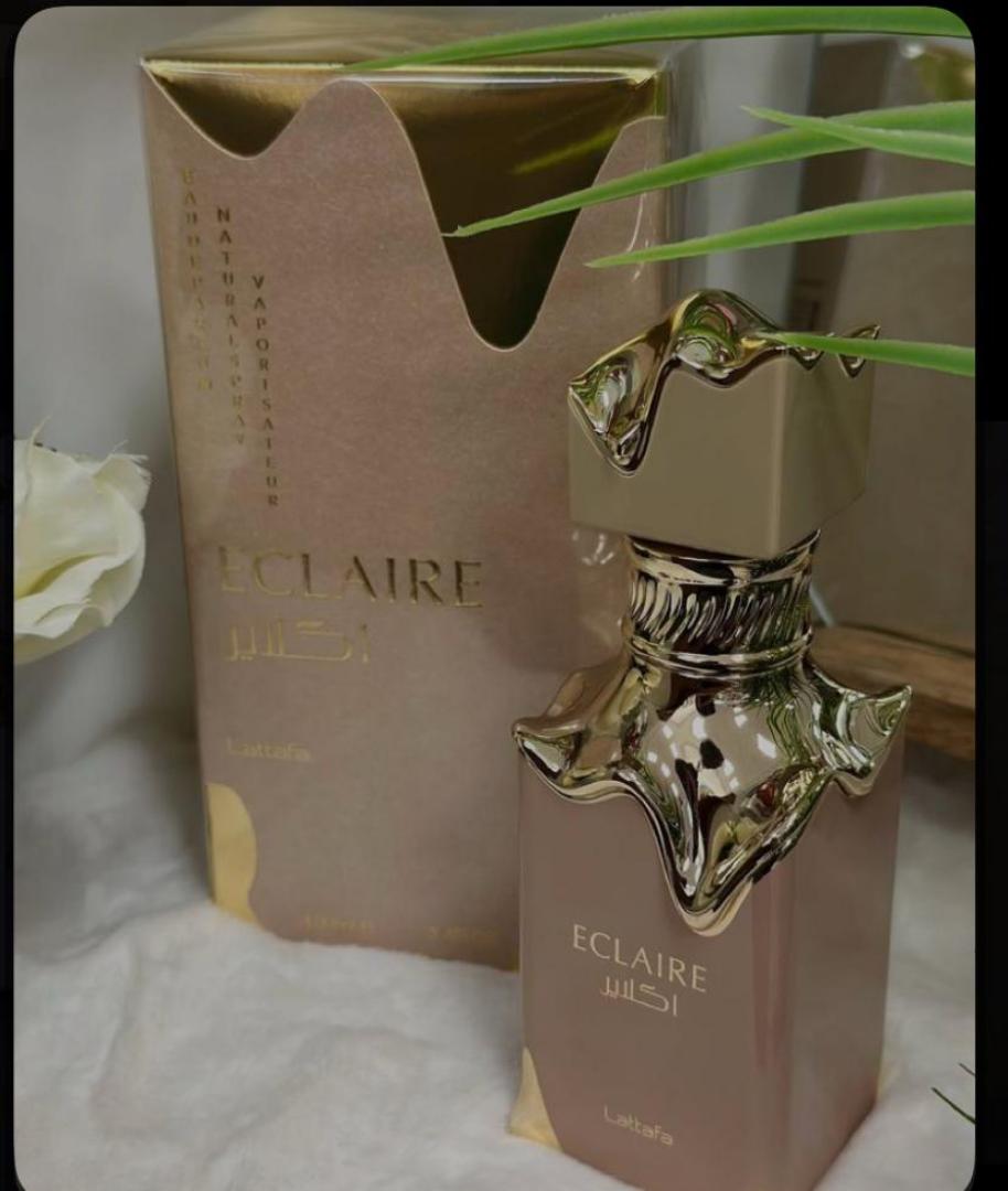 Lattafa Eclaire is a 100ml gourmand Eau de Parfum with a sweet, dessert-like profile. Notes of caramel, vanilla, and sugar create a warm, indulgent scent reminiscent of pastry. The bottle and box fe