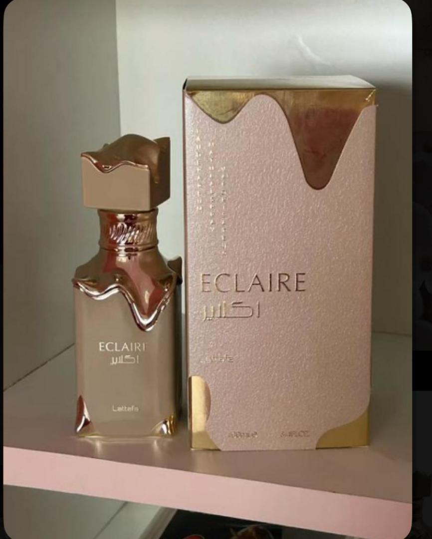 Lattafa Eclaire is a 100ml gourmand Eau de Parfum with a sweet, dessert-like profile. Notes of caramel, vanilla, and sugar create a warm, indulgent scent reminiscent of pastry. The bottle and box fe