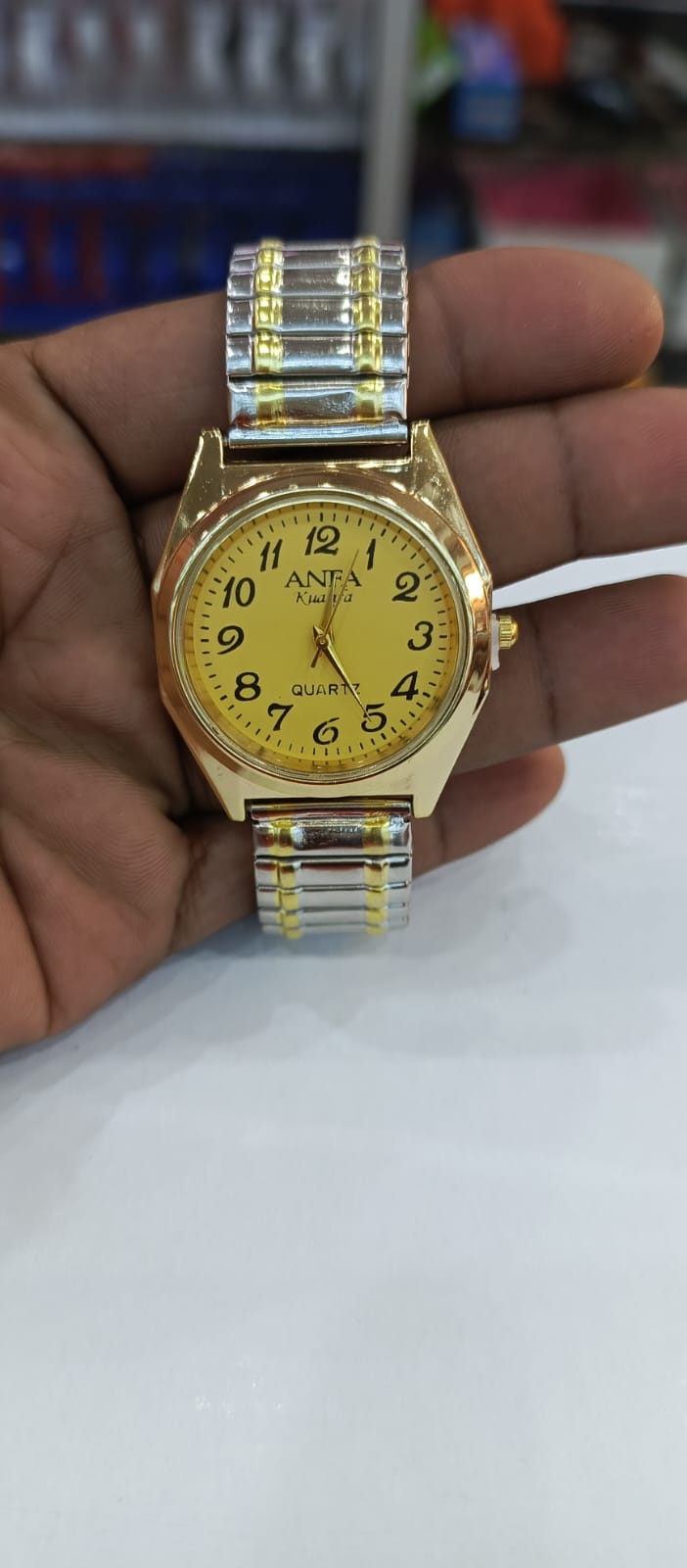 Stylish Good Quality Fashionable Elastic Gold-Silver watch featuring a quartz movement and a yellow dial with Arabic numerals.