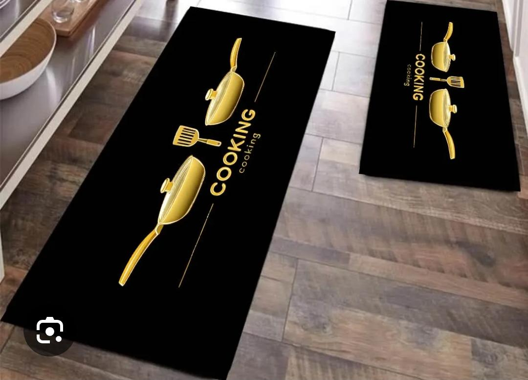 This stylish kitchen floor mat set combines functionality with modern decorative appeal. Featuring a sleek black background accented by elegant gold cookware graphics.