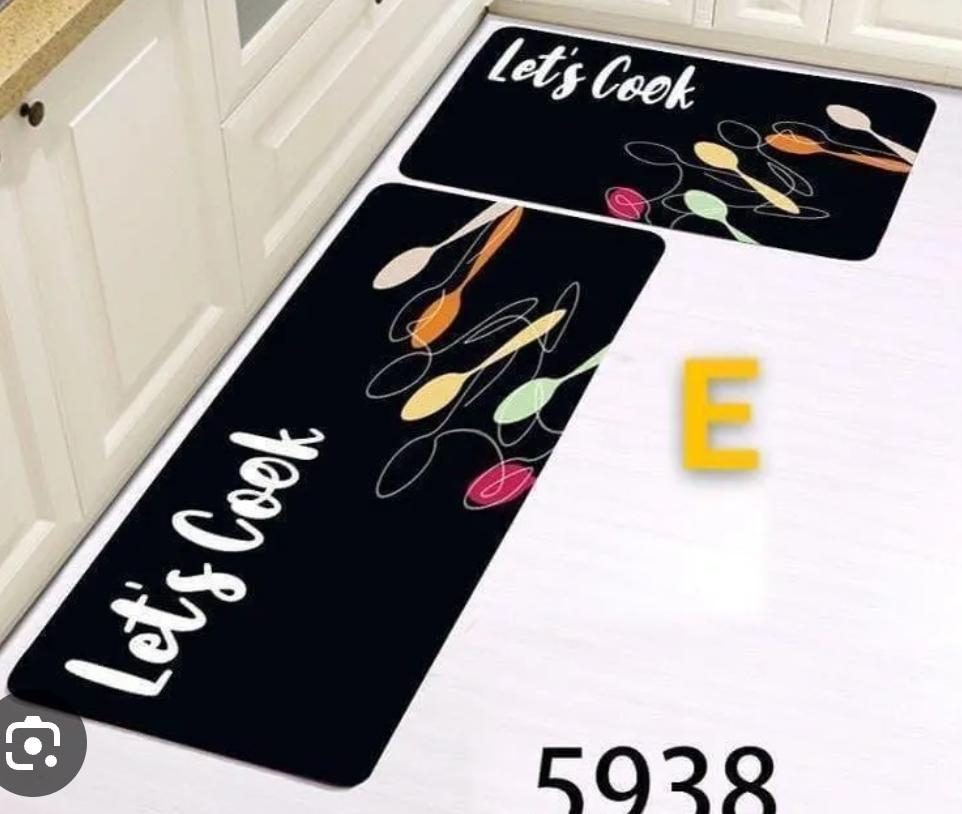 This stylish kitchen floor mat set combines functionality with modern decorative appeal. Featuring a sleek black background accented by elegant gold cookware graphics.