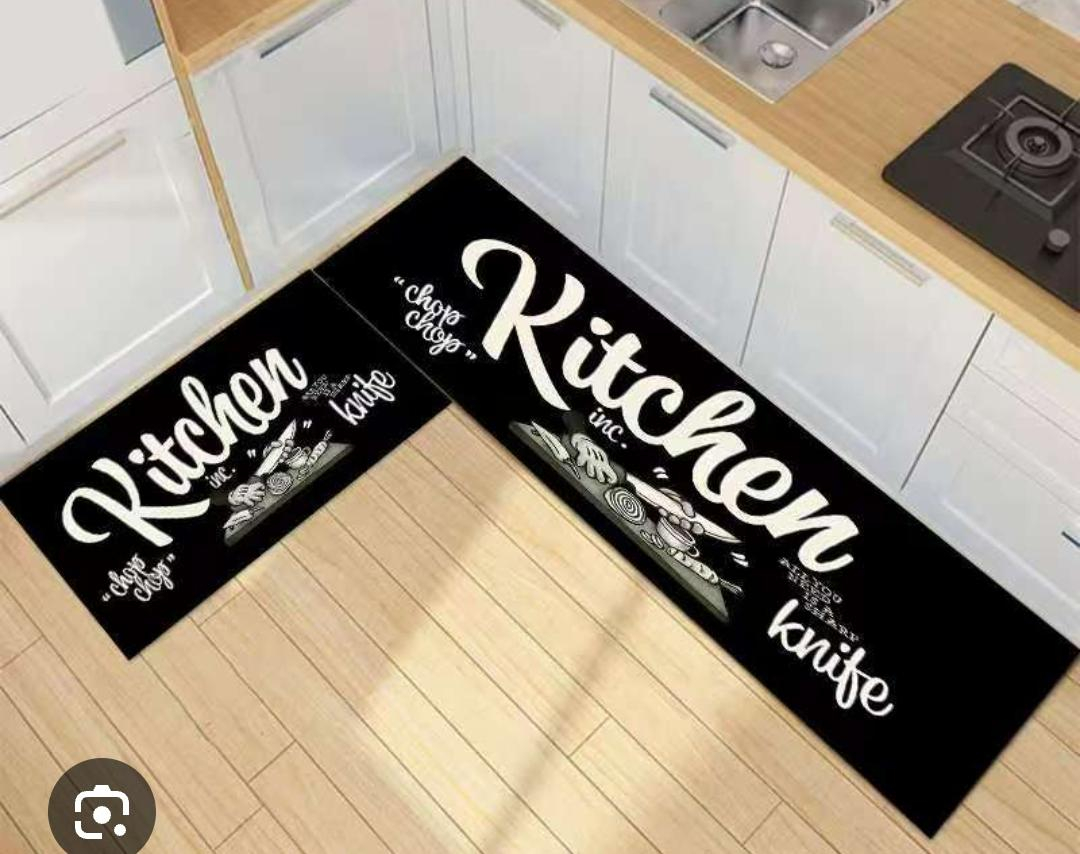 This stylish kitchen floor mat set combines functionality with modern decorative appeal. Featuring a sleek black background accented by elegant gold cookware graphics.