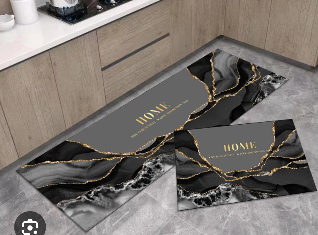 This stylish kitchen floor mat set combines functionality with modern decorative appeal. Featuring a sleek black background accented by elegant gold cookware graphics.