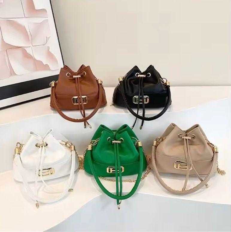 Mini leather sling bag; White elegant mini size leather shoulder handbag with drawstring closure. It comes with a handle. It's perfect for casual outings, work, travel, parties, and special occasions.