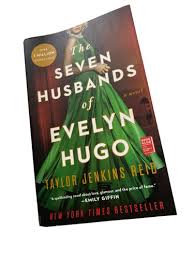 The Seven Husbands of Evelyn Hugo Novel by Taylor Jenkins Reid -  A reclusive aging Hollywood movie icon recounts her glamorous life, relentless ambition, and seven tumultuous marriages to an unknown