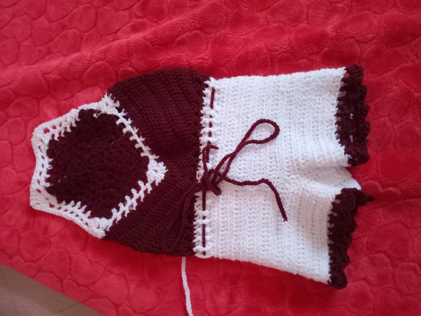 Handmade crotcheted baby rompers and hat.