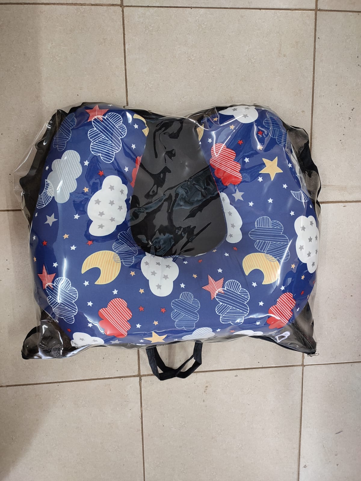 multi-functional baby nursing and feeding pillow set, tightly packed inside a clear plastic protective travel bag with a black zipper trim and handles.Ergonomic Baby Nursing Pillow  Lounger with cover