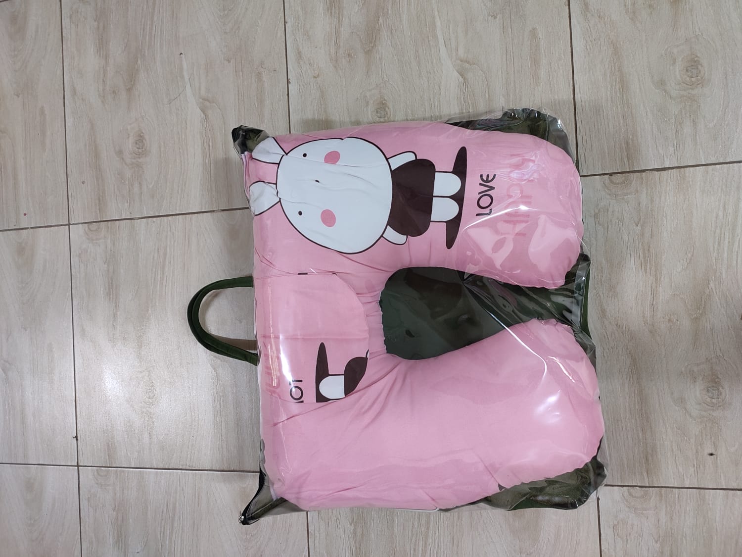 multi-functional baby nursing and feeding pillow set, tightly packed inside a clear plastic protective travel bag with a black zipper trim and handles.Ergonomic Baby Nursing Pillow  Lounger with cover