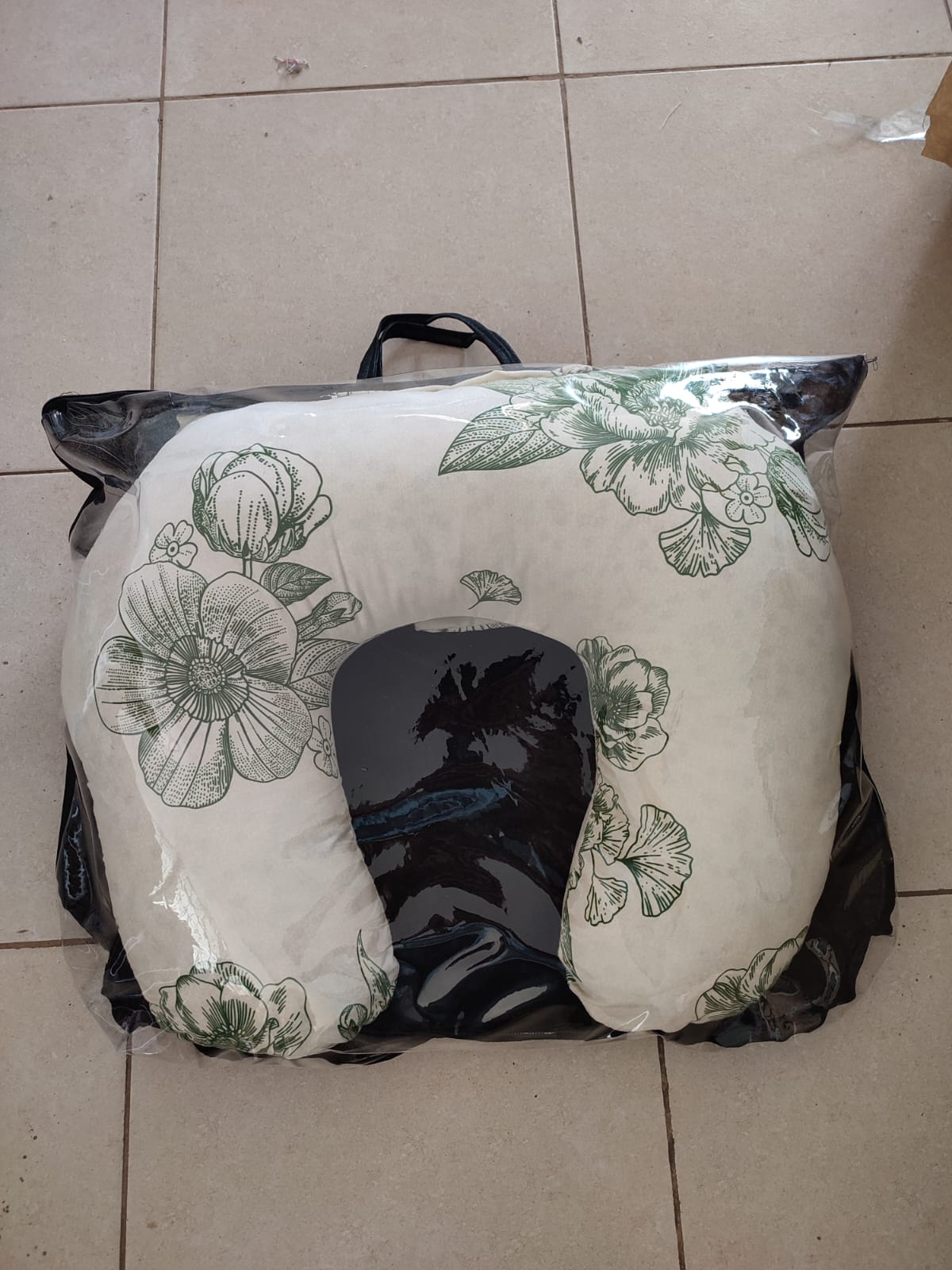 multi-functional baby nursing and feeding pillow set, tightly packed inside a clear plastic protective travel bag with a black zipper trim and handles.Ergonomic Baby Nursing Pillow  Lounger with cover