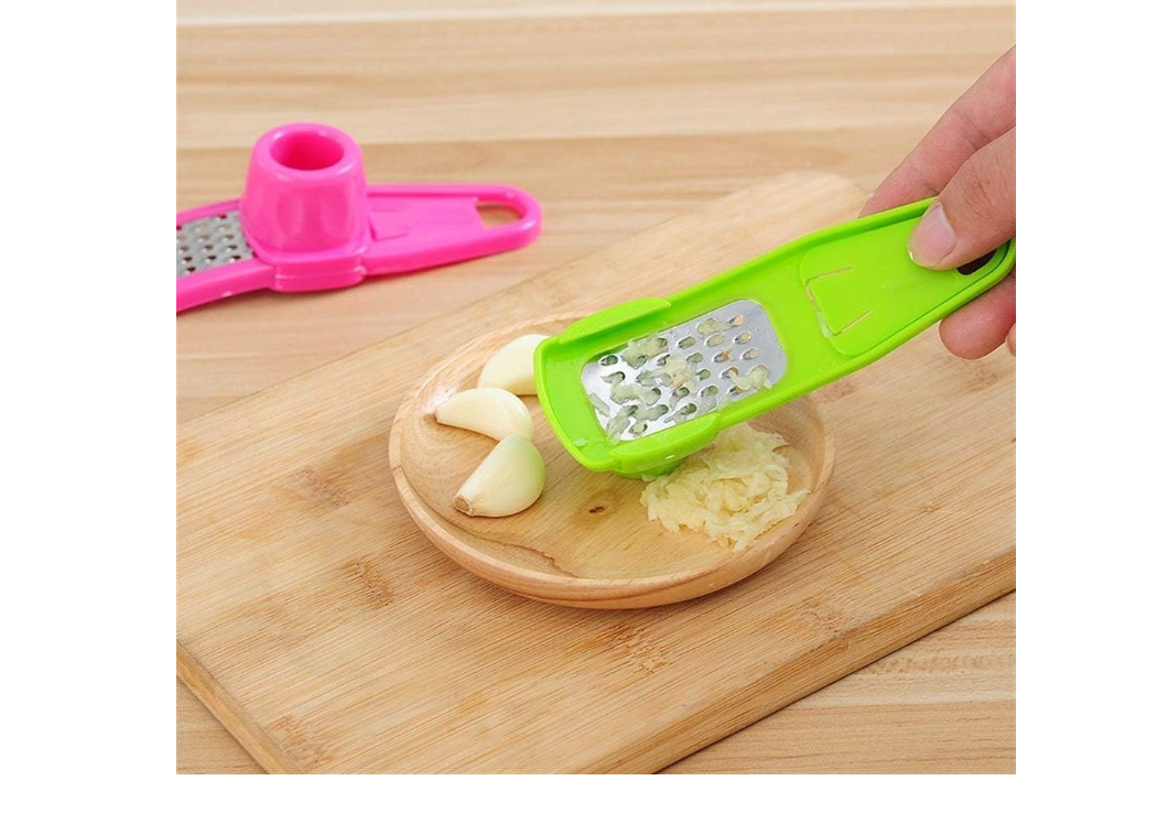 2-in-1 manual ginger and garlic press crusher grinder used for garlic, ginger, and vegetables . It is a compact, handheld kitchen gadget designed to quickly mince, grate, or slice small ingredients